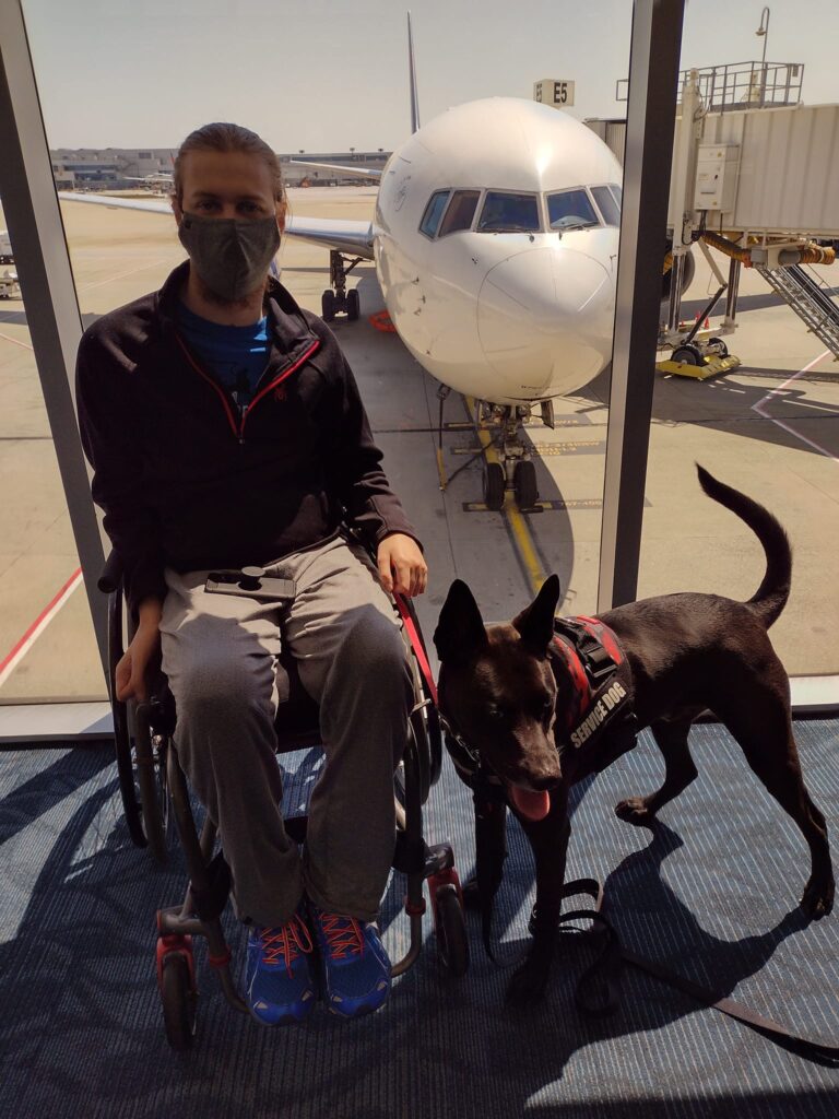 Cougar Clifford stand up for me donation page at the airport with service dog